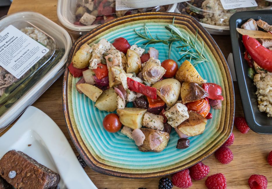 Delicious Mediterranean meal with roasted vegetables and herbs on a turquoise plate, ideal for healthy eating promotions.
