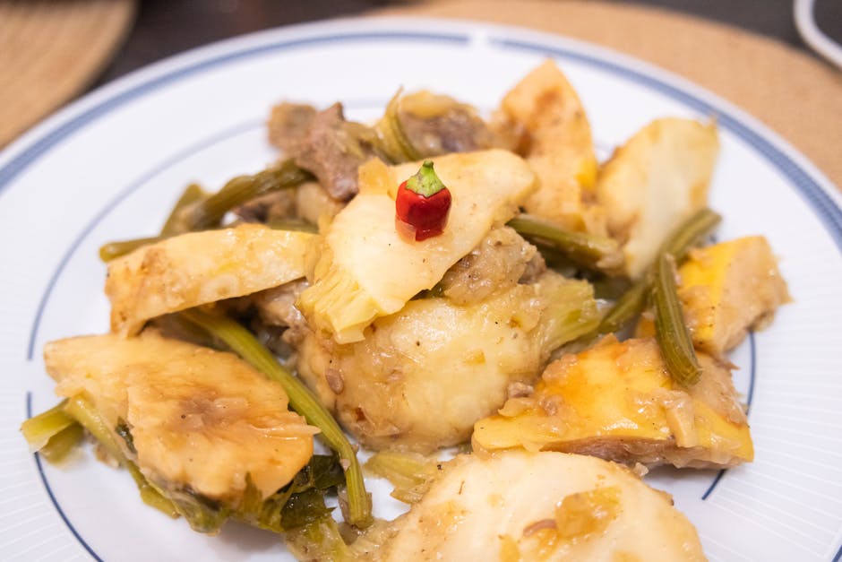Delicious İzmir style artichoke dish garnished with a red pepper, perfect for Turkish cuisine lovers.